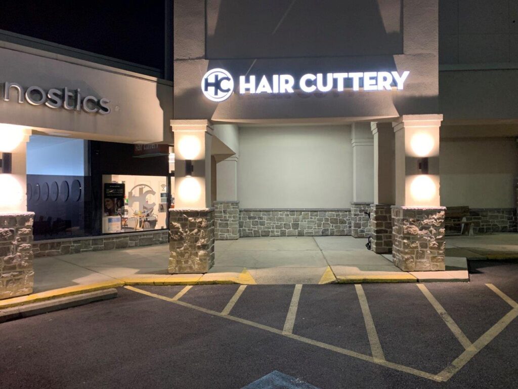 A night time photo outside the front entrance of a Hair Cuttery