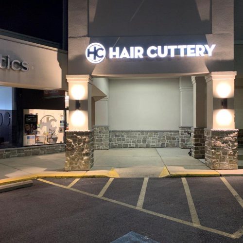 A night time photo outside the front entrance of a Hair Cuttery
